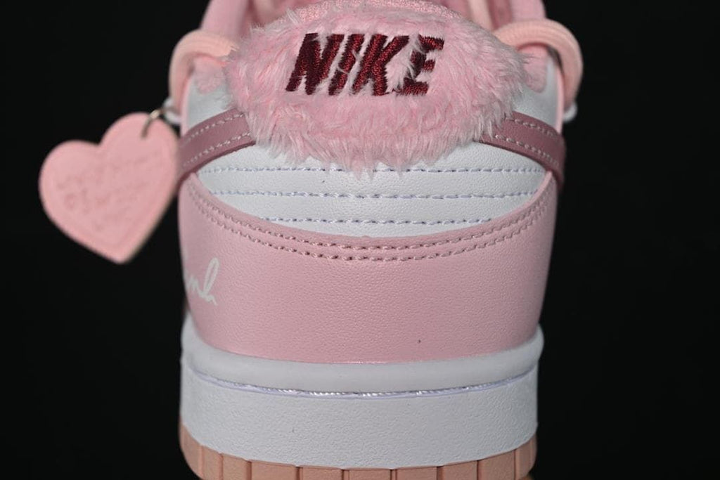 Rear close-up showing pink heel panels and a fuzzy Nike heel accent.