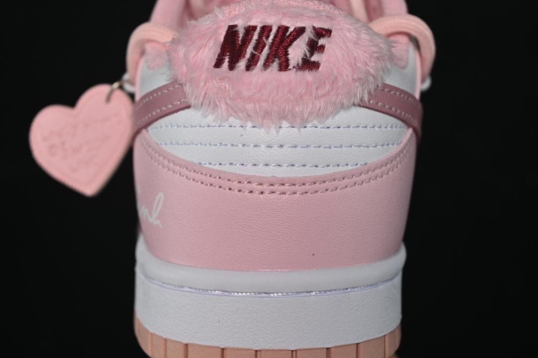 Rear close-up showing pink heel panels and a fuzzy Nike heel accent.