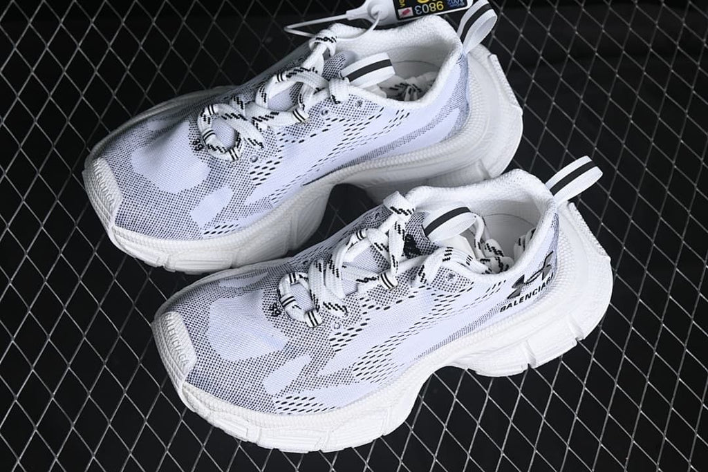 Pair of white and black low-top sneakers shown from above.
