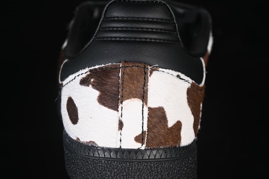 Rear view showing the cow-print heel panel, black heel counter and black outsole