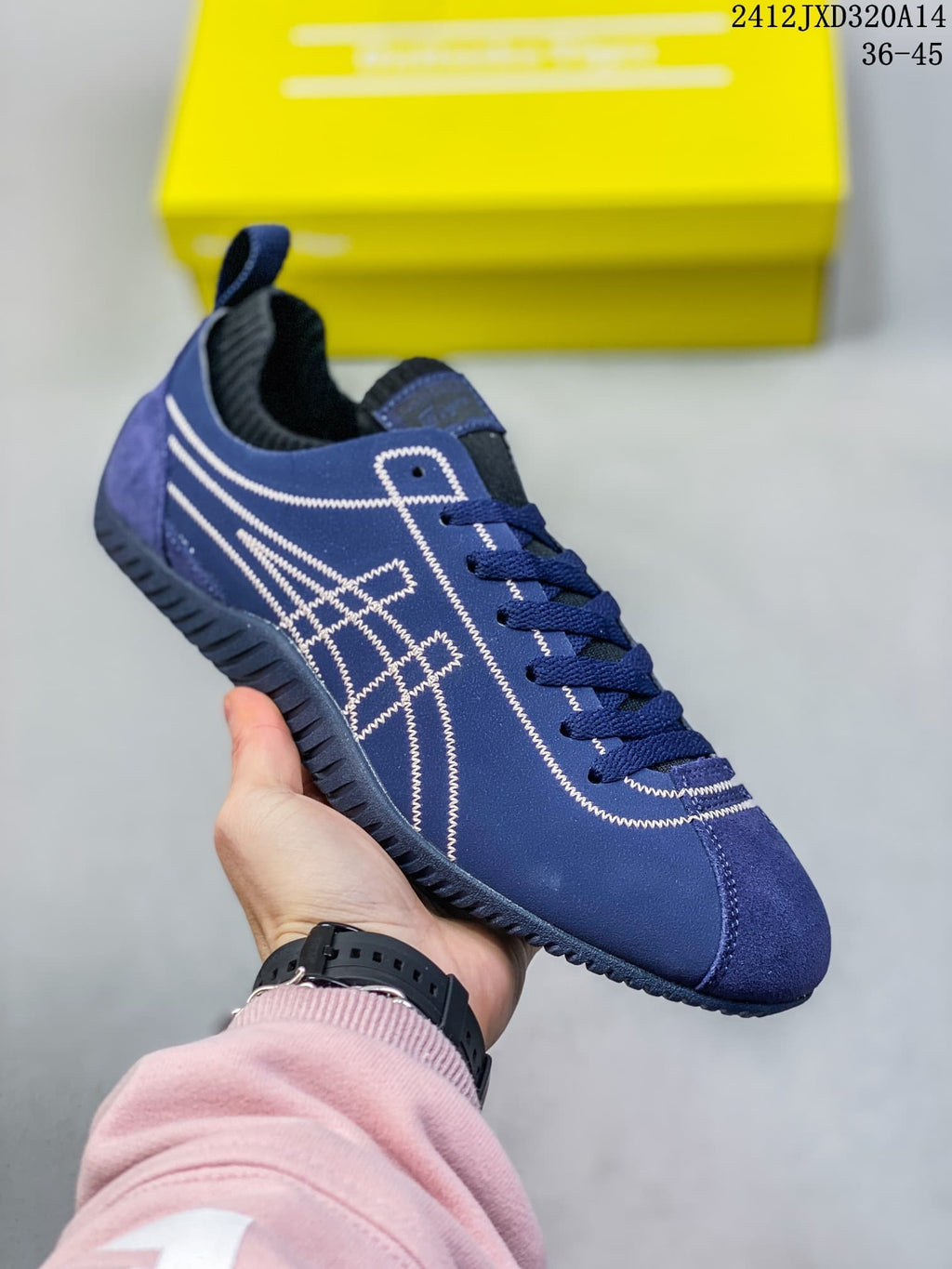 Angled side view of the blue low-top sneaker with white stitched detailing