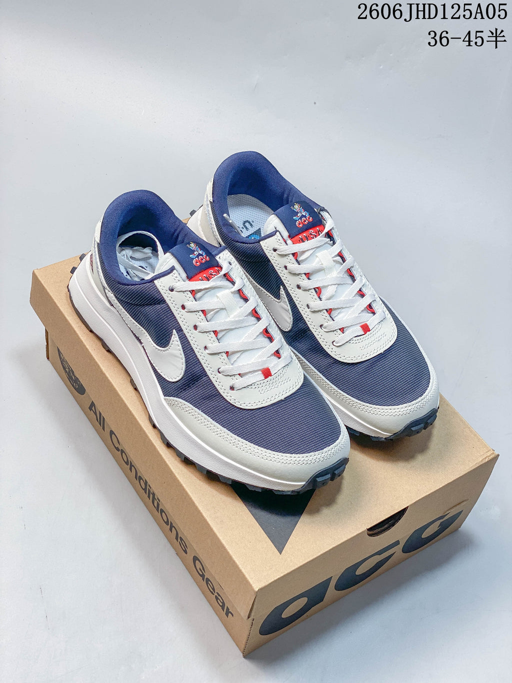 Pair of navy and white Nike ACG LDV sneakers displayed on a box