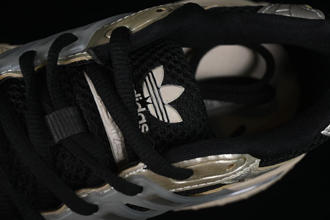 Close-up of black laces, tongue and trefoil logo