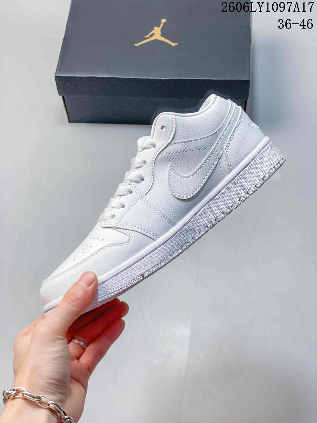 Side view of a white low-top sneaker with a Swoosh detail