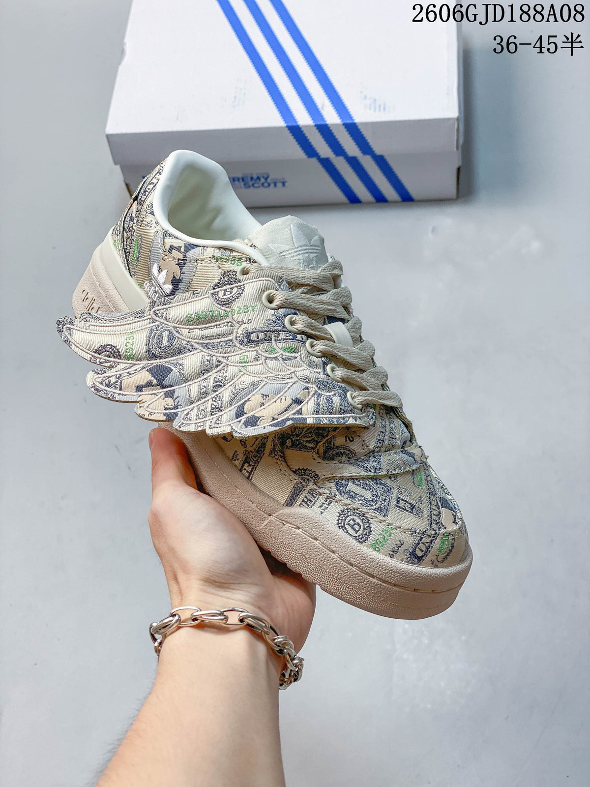 Angled close-up of the banknote-print sneaker and its wing-shaped side detail