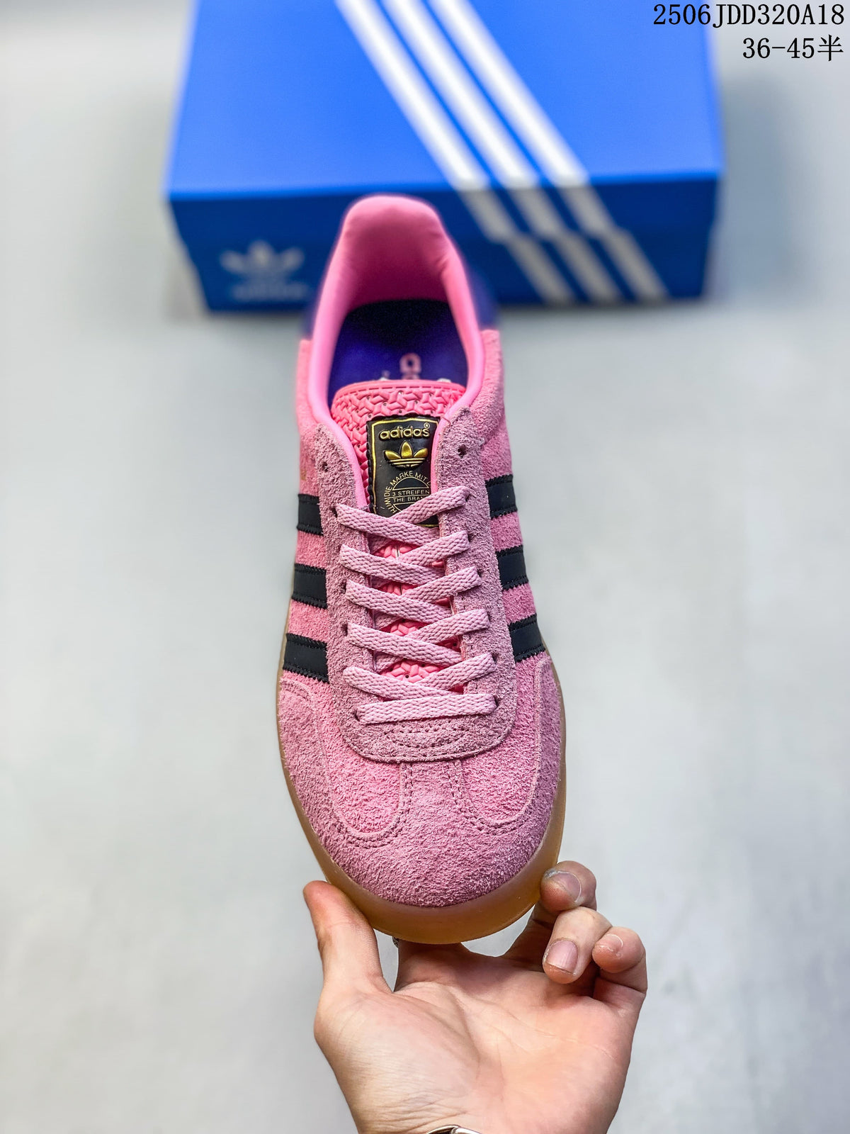 Front view of the pink Gazelle sneaker showing its laces and textured upper
