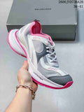 White and gray Balenciaga Circuit-style sneaker with pink accents and a thick sculpted sole