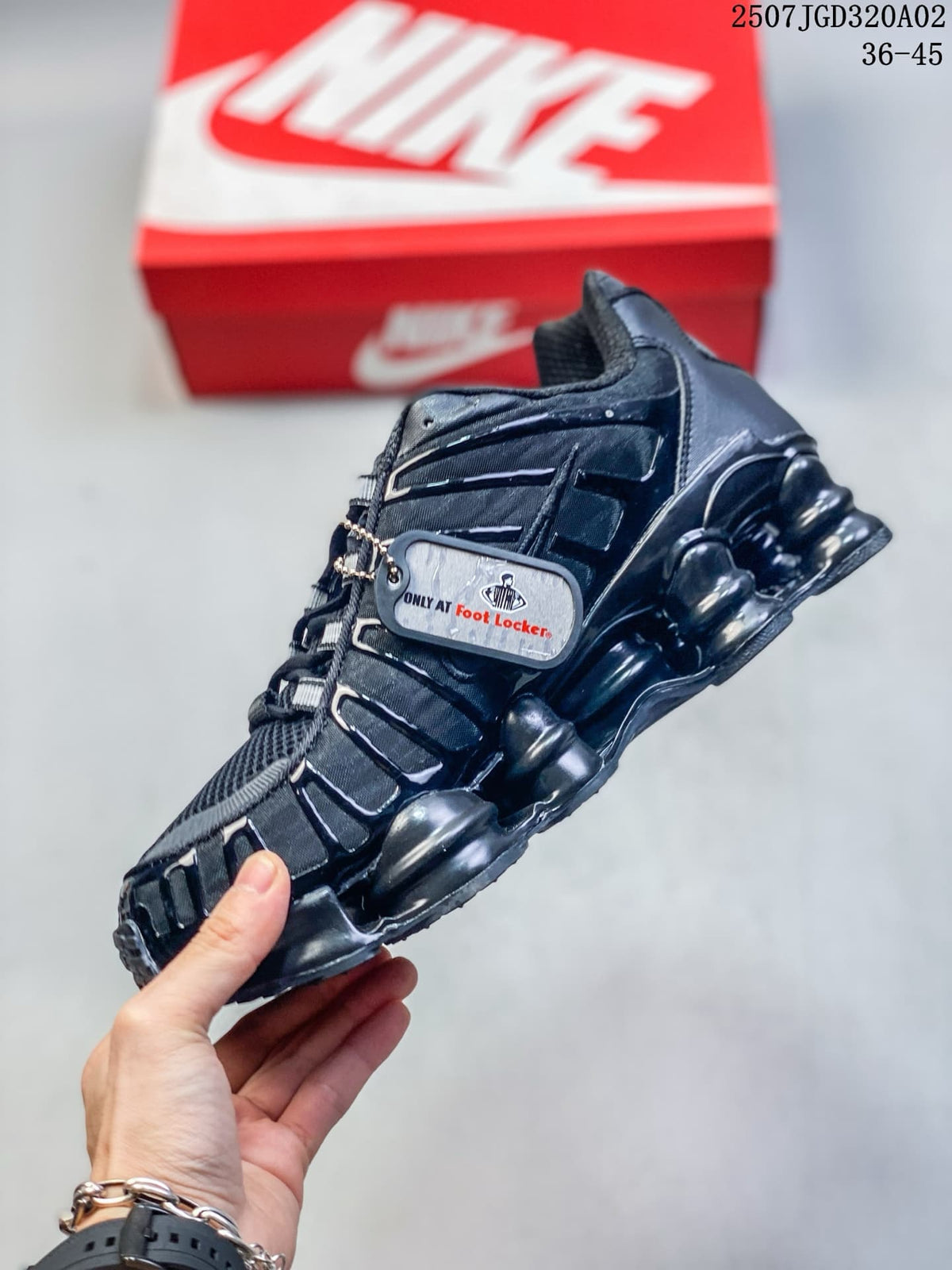 Side view of a black Nike Shox TL sneaker with a hanging tag