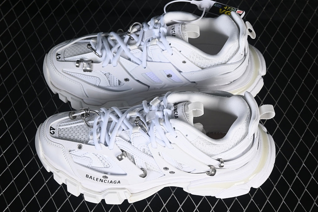 Pair of white Track Piercing sneakers viewed from above.
