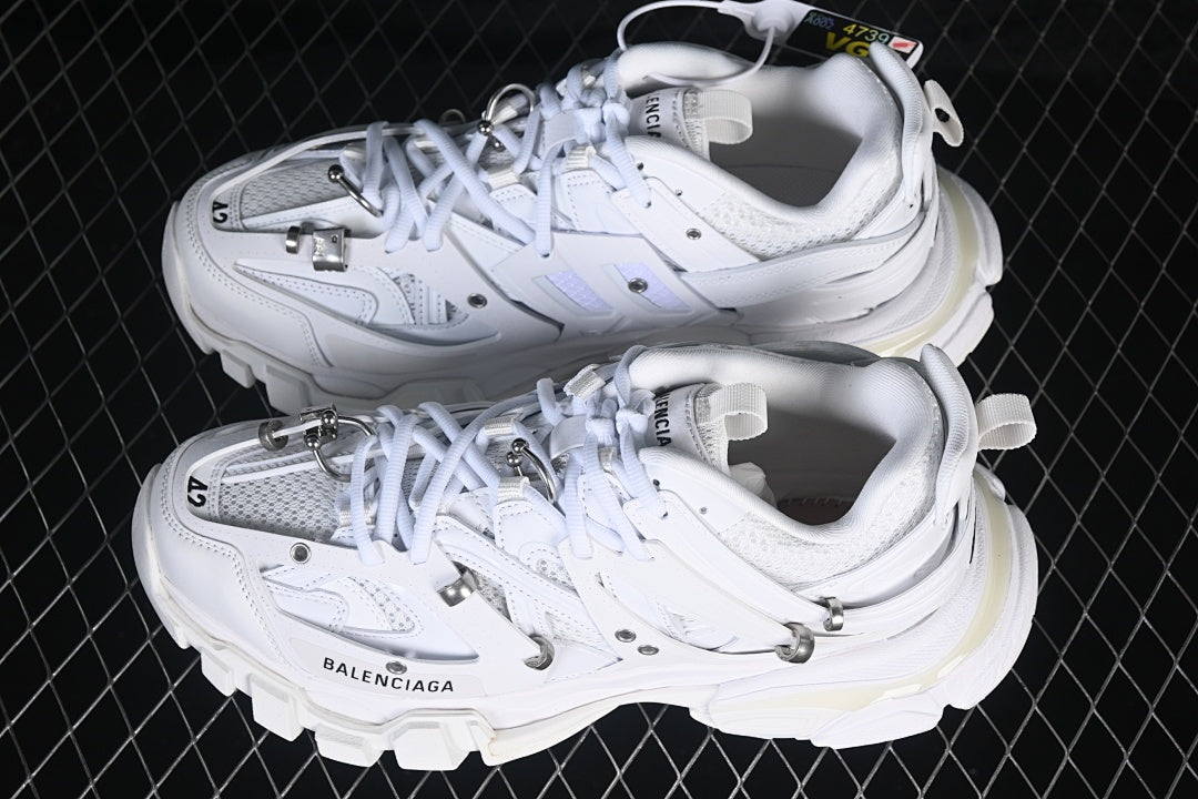 Pair of white Track Piercing sneakers viewed from above.
