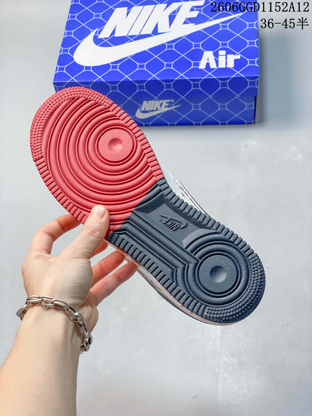 View of the sneaker outsole with red and dark gray sections