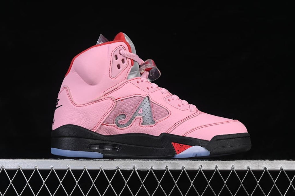 Side profile of the pink high-top sneaker with red and black accents.