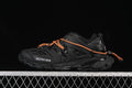 Black Balenciaga Track sneaker with orange laces, shown in side profile.
