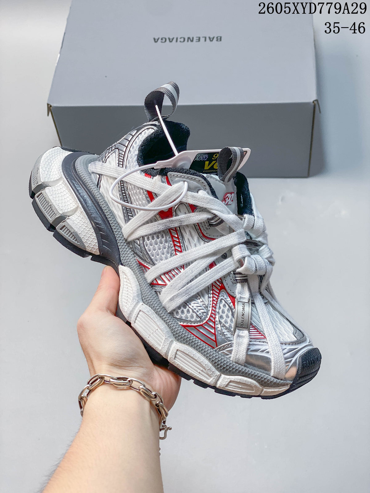 Close-up of a silver and white Balenciaga Phantom sneaker with red accents.