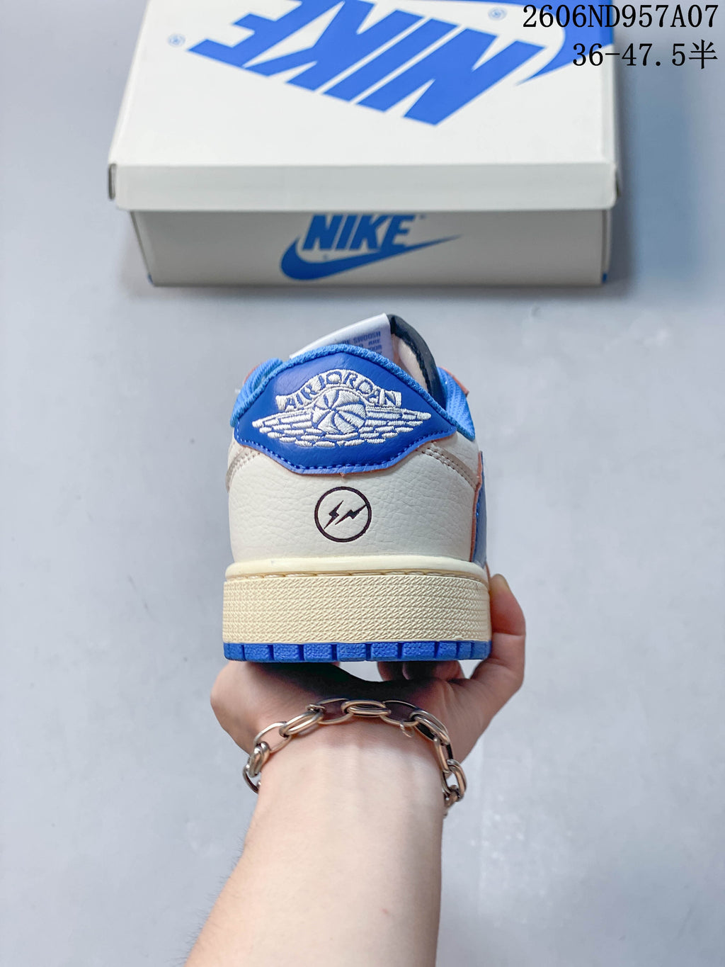 Rear view showing blue heel tab and off-white upper