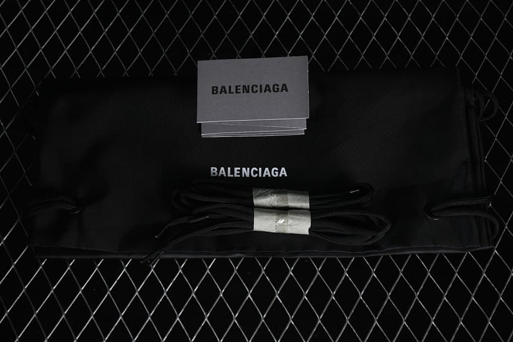 Balenciaga-branded black dust bag, spare laces and booklet