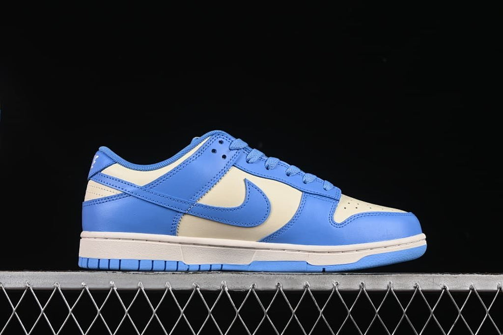 Side profile of a blue and cream low-top sneaker