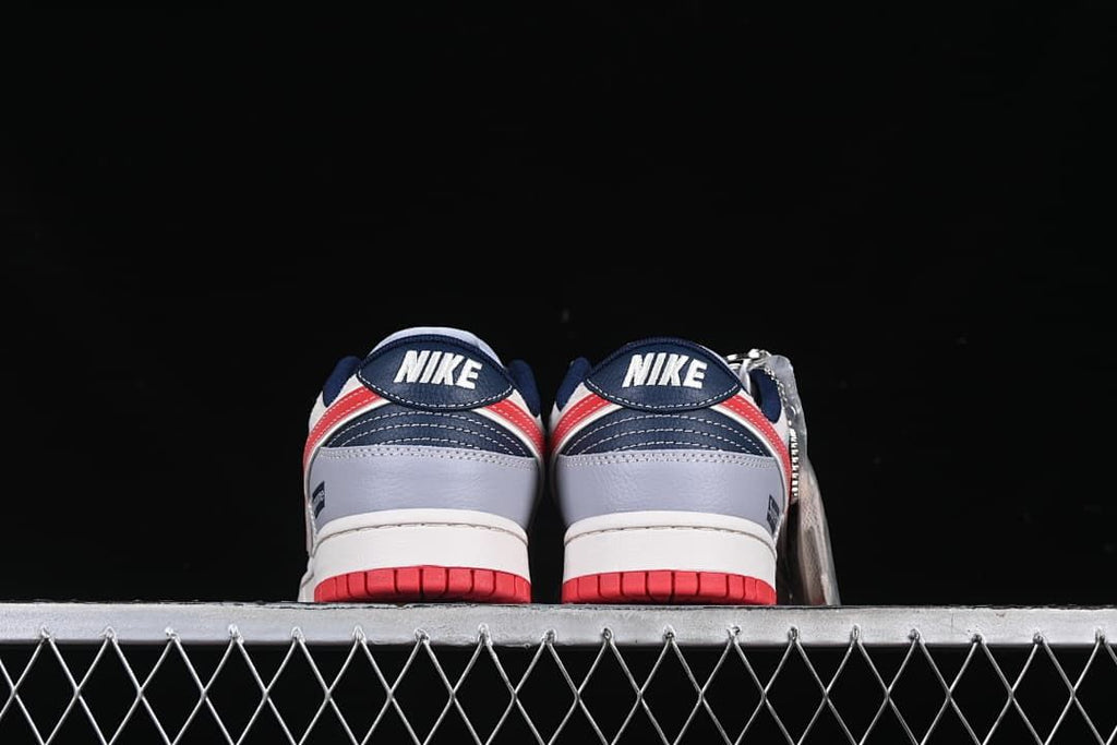 Rear view of the pair showing heel panels and red outsole accents