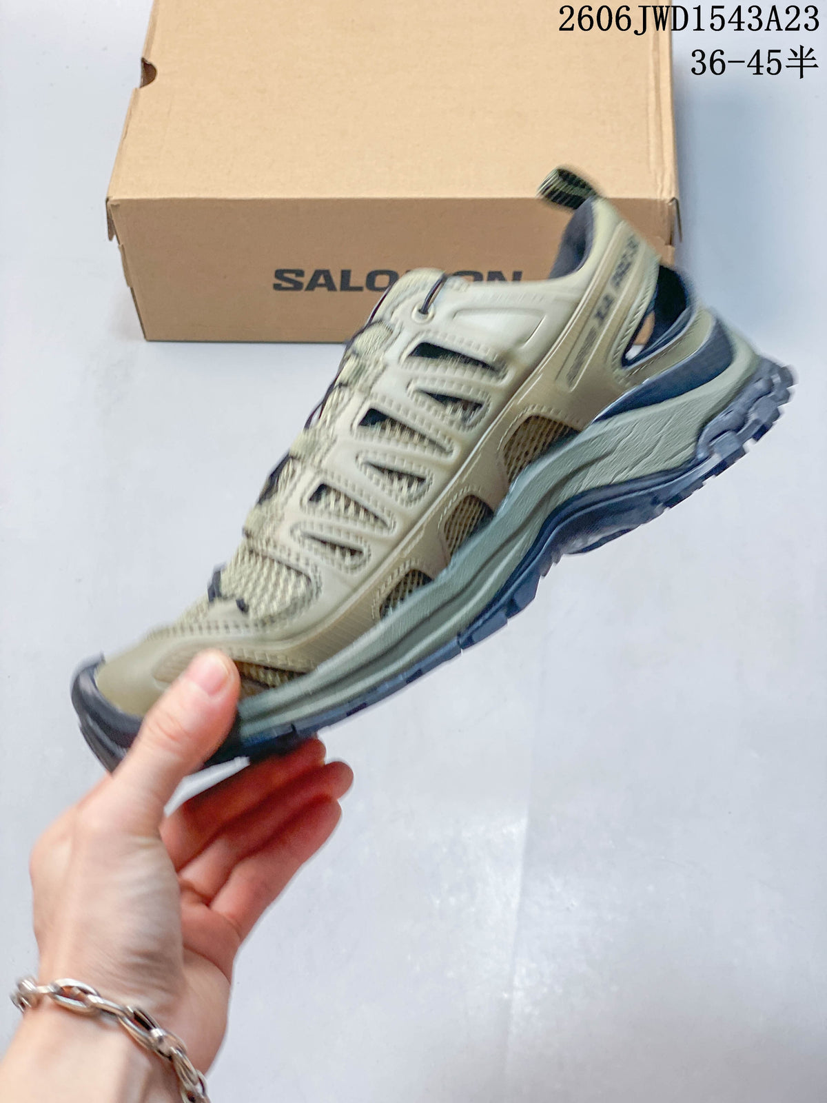 Side view of the olive-toned low-top shoe with mesh panels and cage-style overlays