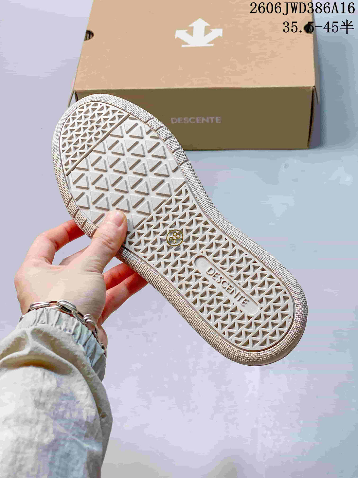 Close-up of the patterned outsole on a white DESCENTE sneaker