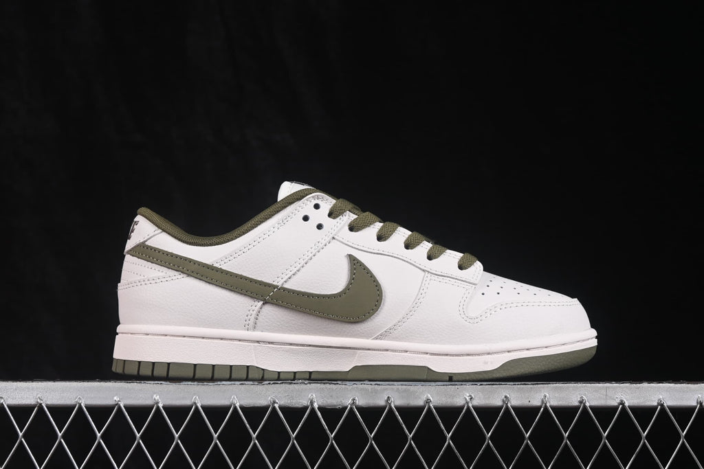 Side profile showing the white sneaker upper, olive Swoosh, olive laces, and low-top sole.