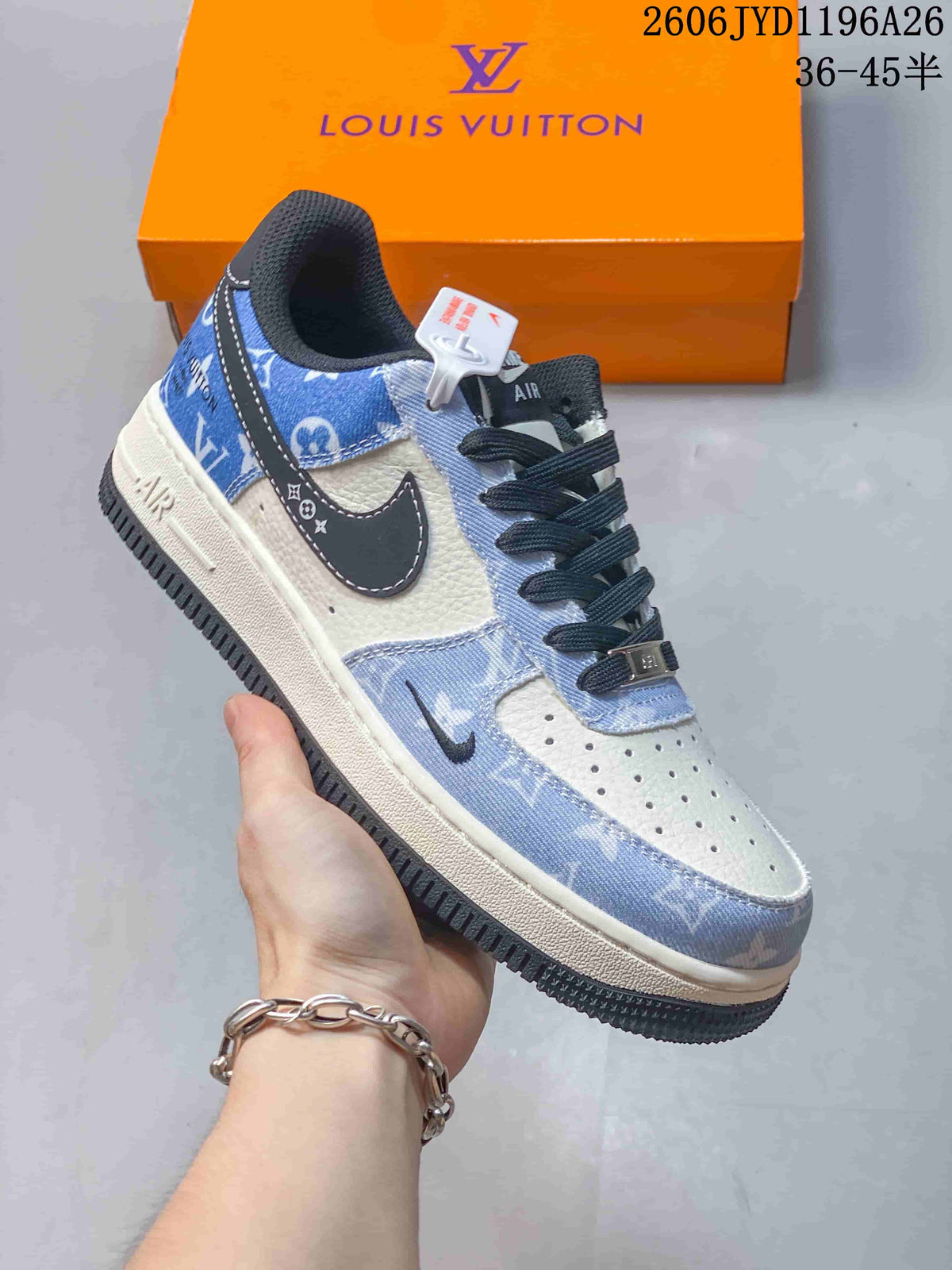 Blue-and-white low-top sneaker with dark laces and monogram-pattern panels, held in front of an orange box.