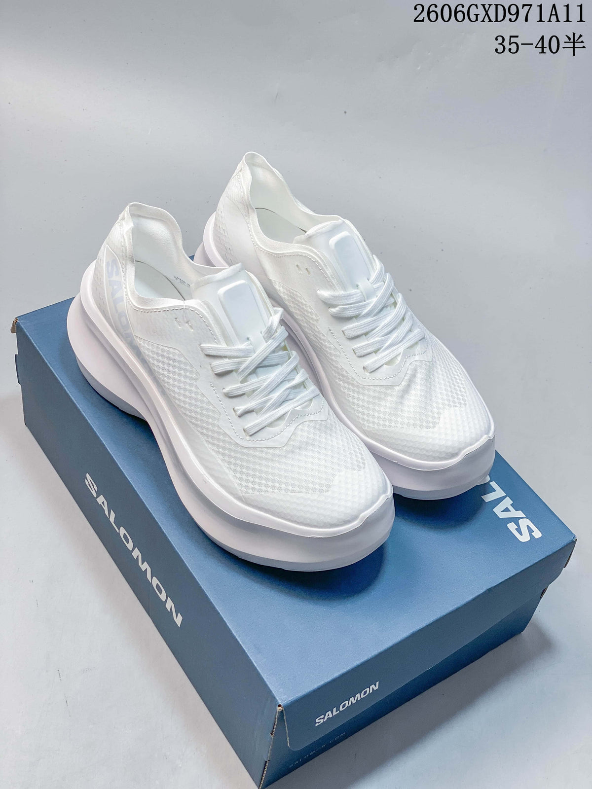 Pair of white Salomon Phantasm low-top sneakers on a blue shoebox