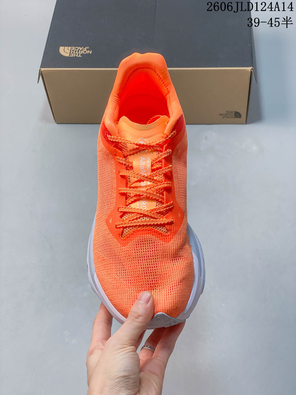 Top view of the orange lace-up running shoe