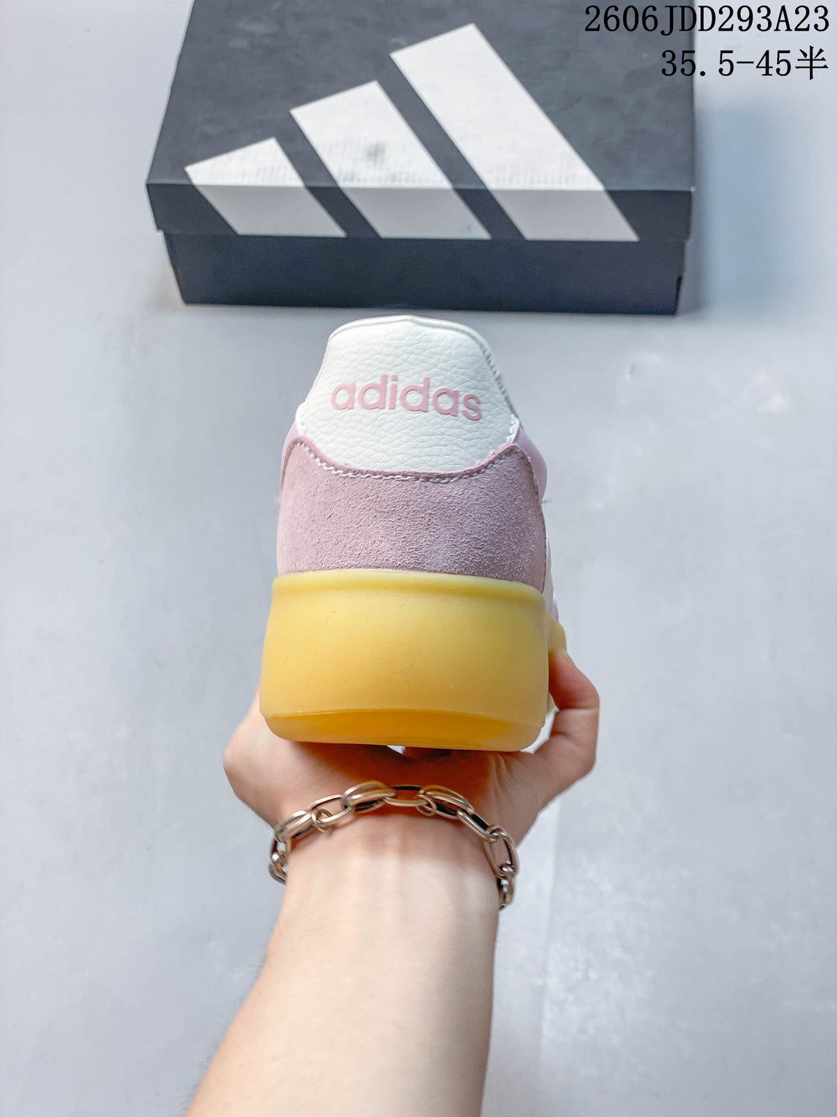 Rear view showing the pink heel panel and gum-colored sole