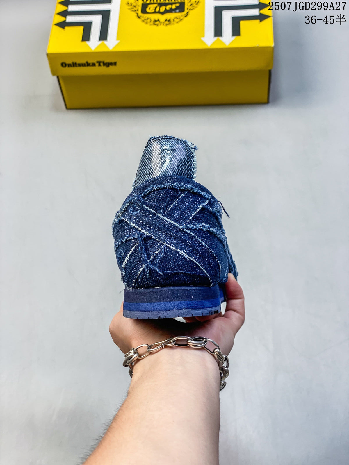 Rear view showing the layered heel and seams of the dark blue sneaker