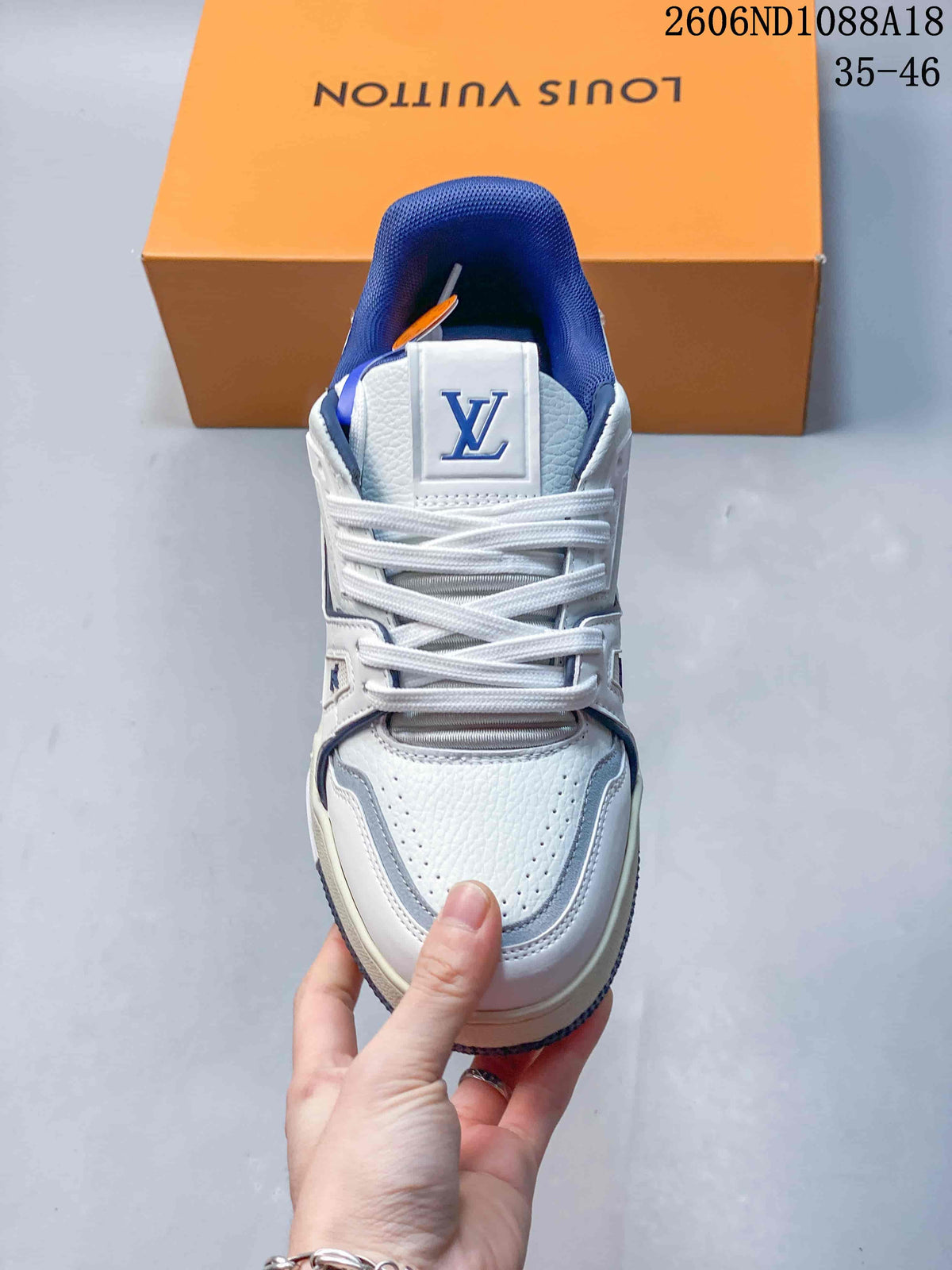 Top view showing white laces, perforated panels, and a blue padded collar