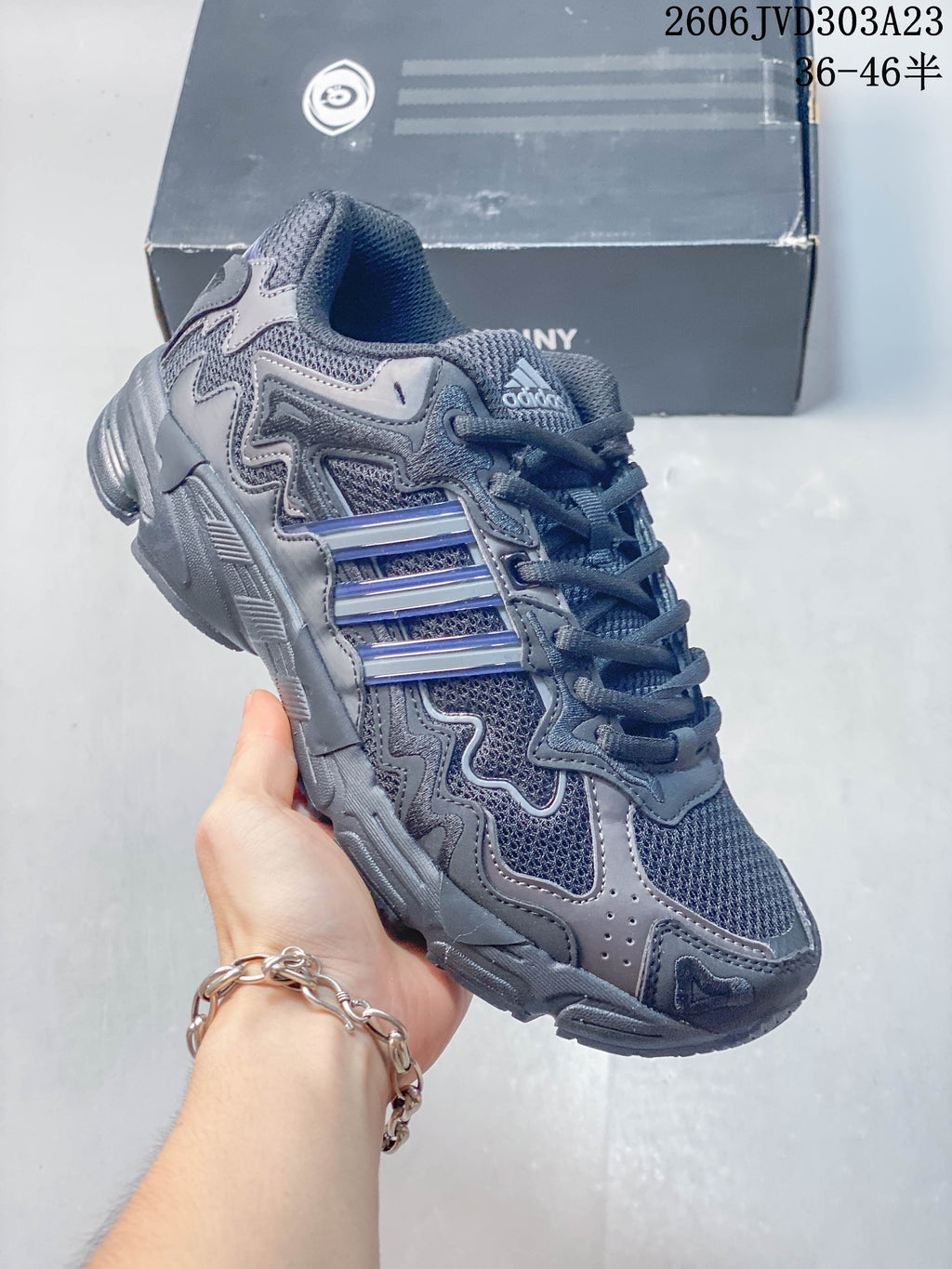 Charcoal gray adidas Response CL sneaker with layered panels and blue-accented side stripes