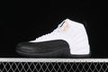 Side view of a white and black Air Jordan 12 high-top sneaker against a dark background.
