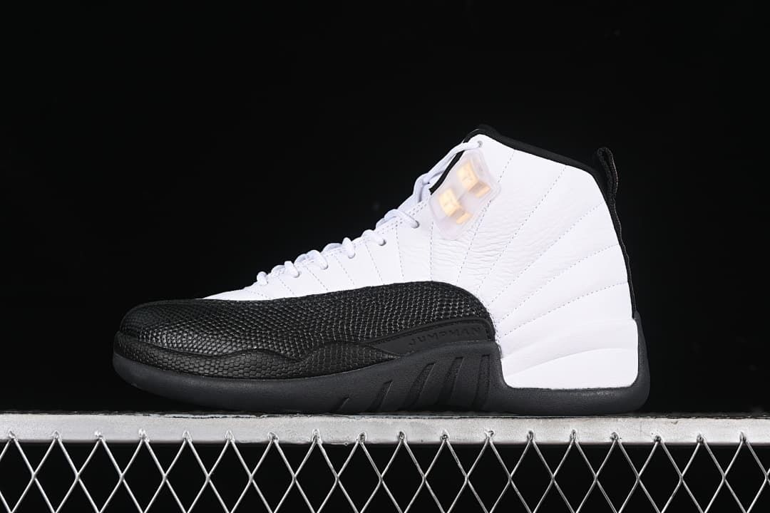 Side view of a white and black Air Jordan 12 high-top sneaker against a dark background.