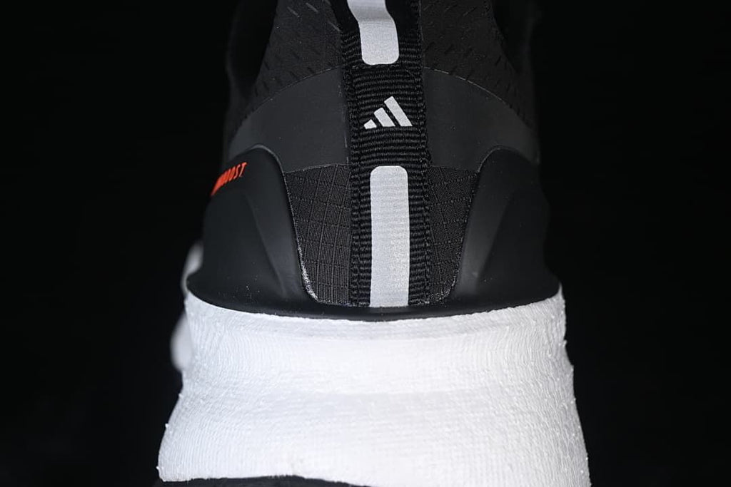 Rear view showing the heel pull tab, adidas logo, and white midsole.