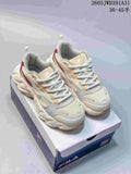 Pair of ivory FILA Croissant 1S sneakers with beige and burgundy accents, shown on a shoebox