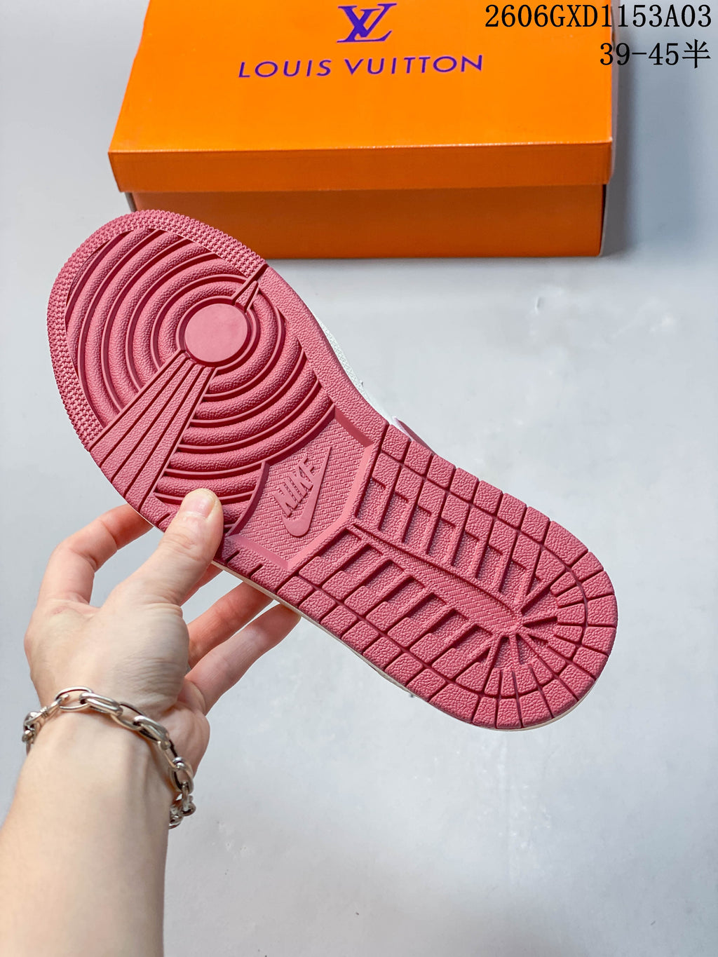 Close-up of the pink patterned outsole on a white and pink low-top sneaker.