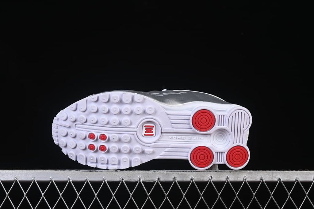 Outsole with circular tread details and red accents