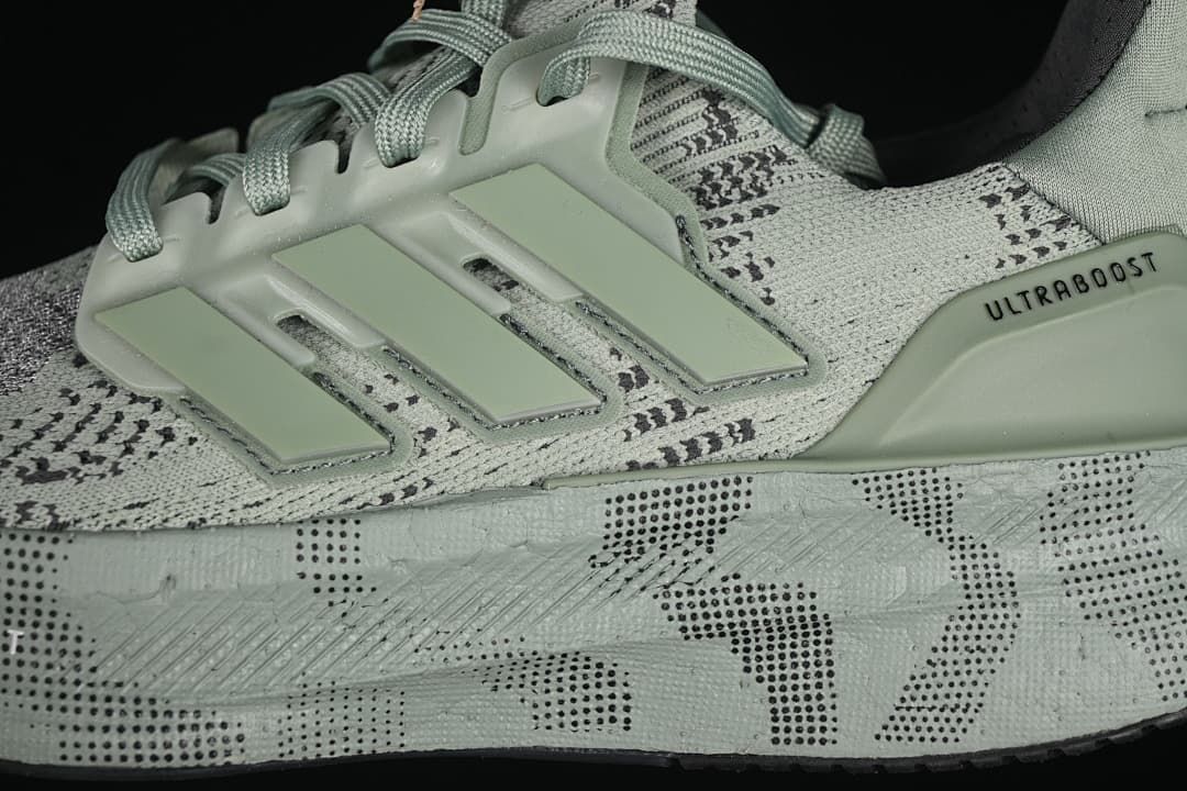 Close-up of the three-stripe side detail, patterned upper and midsole
