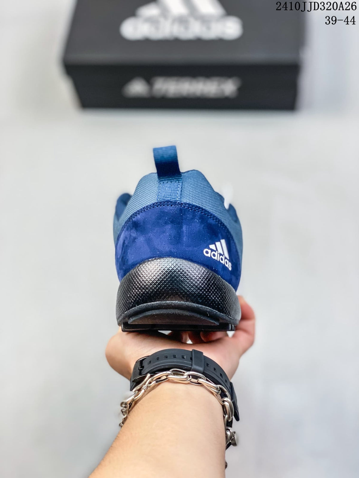 Rear view of the blue adidas Daroga Plus Canvas shoe, showing the heel pull loop and dark heel section.