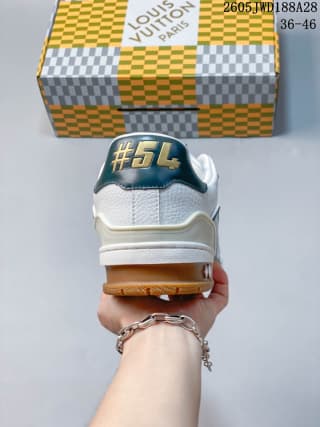 Rear view of the sneaker with white heel panels and gum-colored outsole