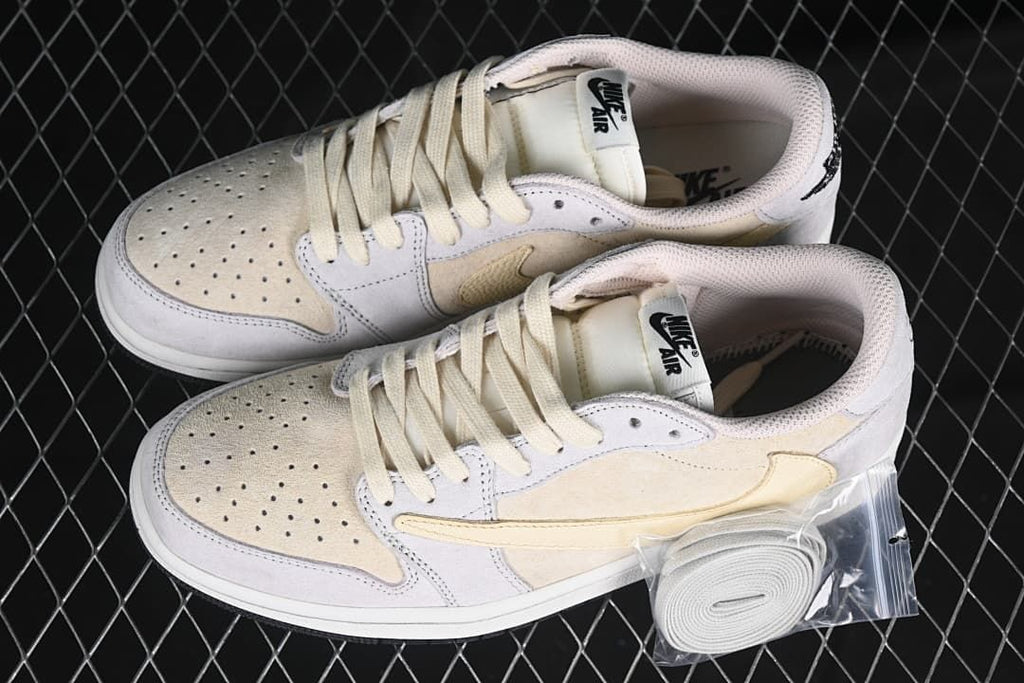 Pair of light neutral low-top sneakers with an extra lace set