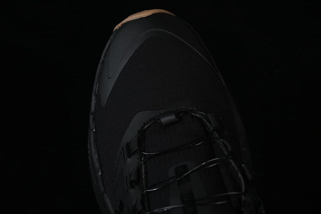 Top view of the black shoe toe and laces.