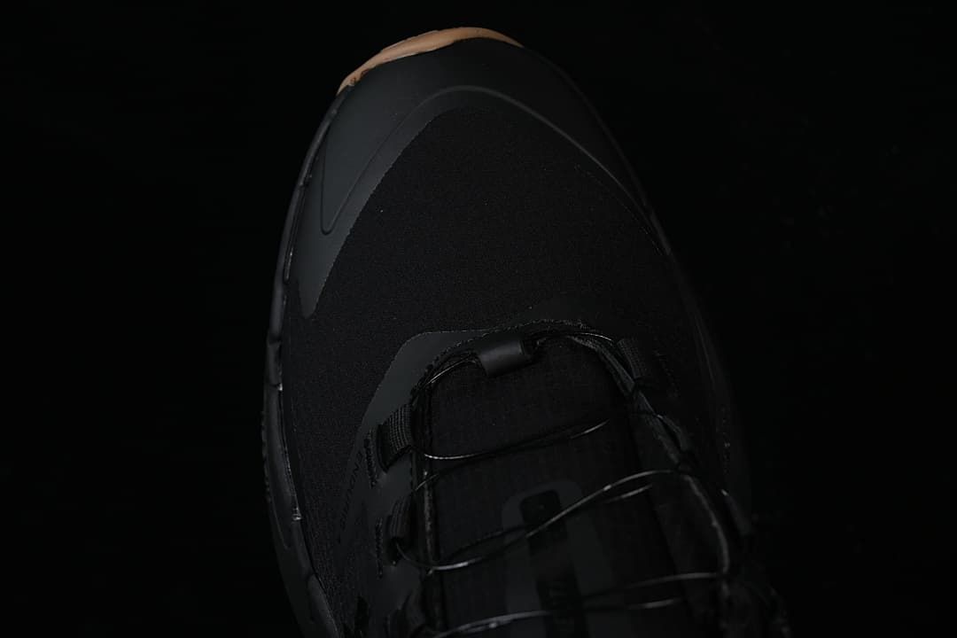 Top view of the black shoe toe and laces.