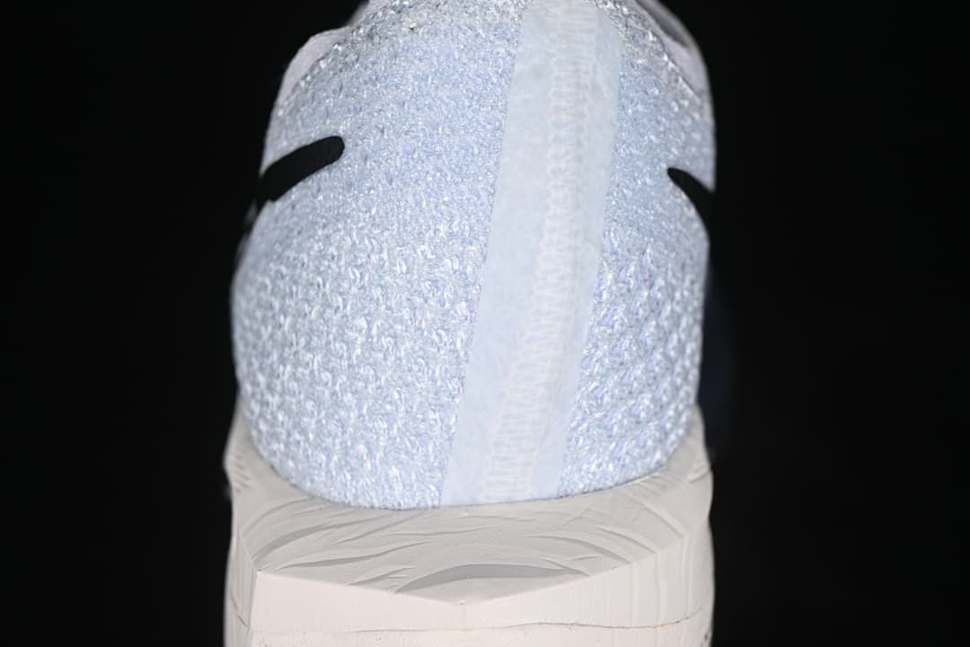 Rear view of the textured white heel and sculpted sole