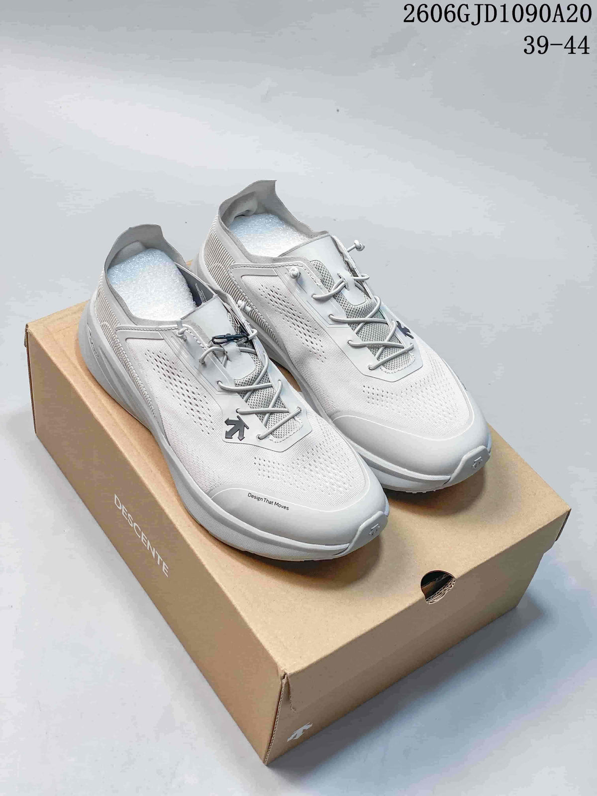 Pair of white and light gray Descente Lavitate 3.0 Wire shoes on a box