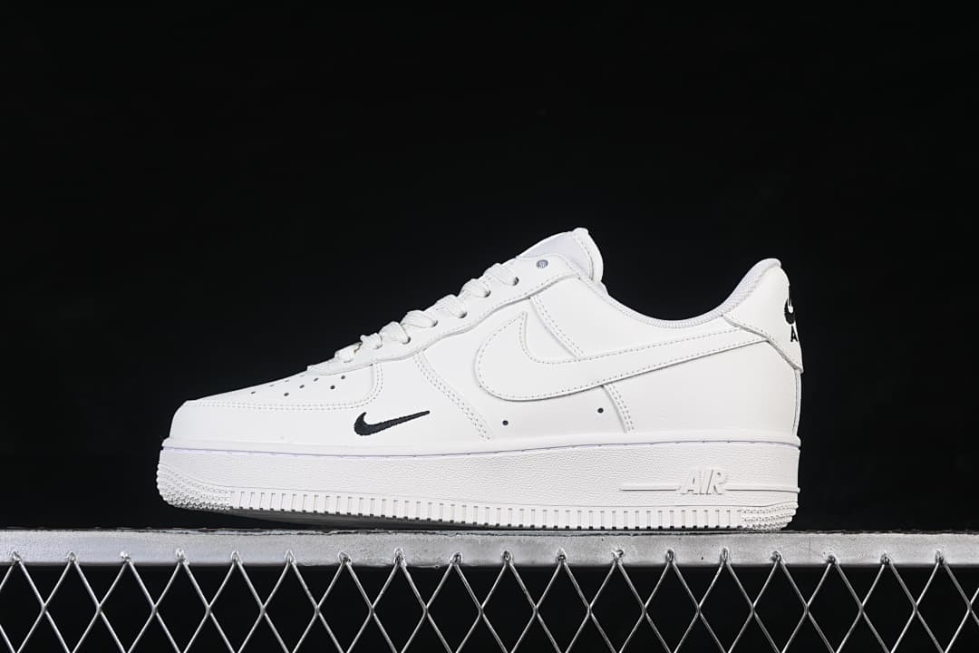 Side view of a white low-top Air Force 1 ’07 sneaker with small black Swoosh accents
