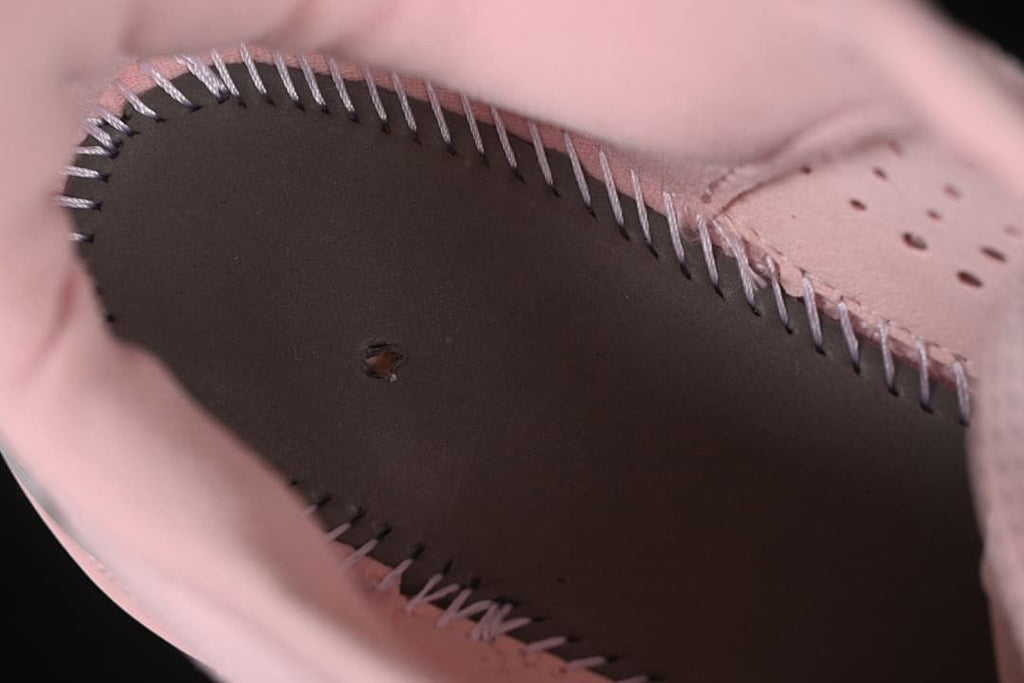 Close-up of interior stitching and construction inside the pink shoe