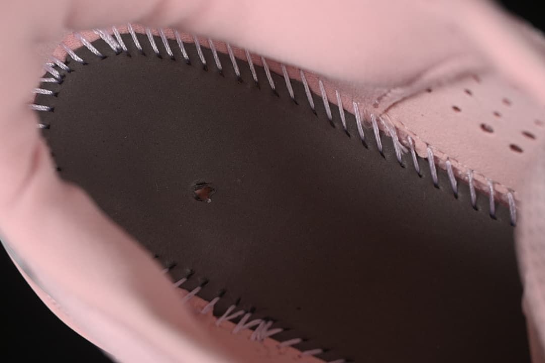 Close-up of interior stitching and construction inside the pink shoe
