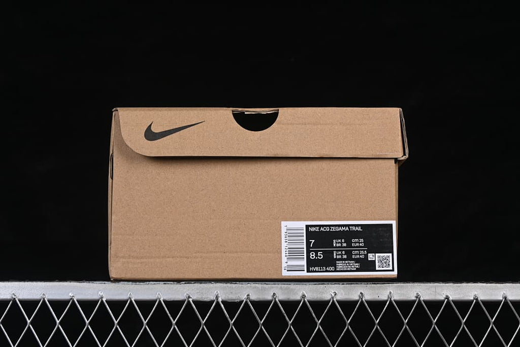 Shoe box with a label identifying Nike ACG Zegama Trail and style code HV8113-400; the label shows US 7 and US 8.5 size rows.